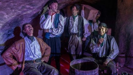 Smuggler figures gathered in a cave at Smugglers Adventure